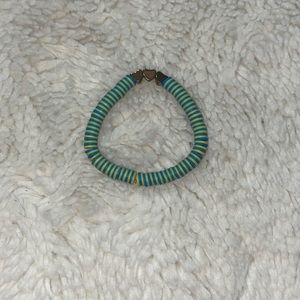 Blue and yellow bracelet with hearts in the middle